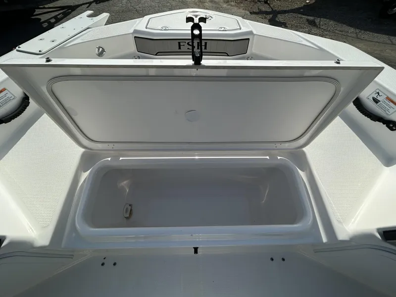 Slide: The Image of Open storage compartment on 2021 Yamaha Boats 195 FSH Sport. - 9