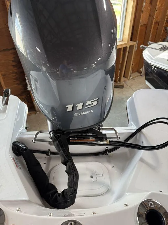 Slide: The Image of 2025 Stingray 182SC boat with Yamaha 115 engine in a garage setting. - 11