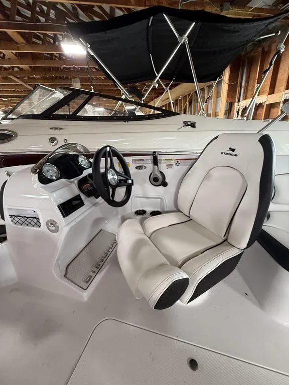 Slide: The Image of 2025 Stingray 182SC boat interior with steering wheel and white seating. - 14
