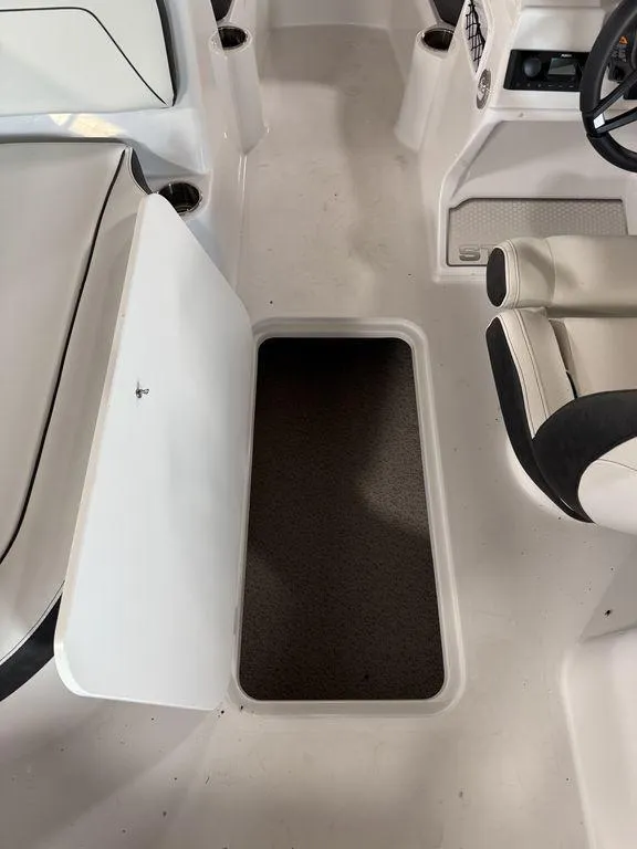Slide: The Image of 2025 Stingray 182SC boat interior with open storage compartment and seating. - 15