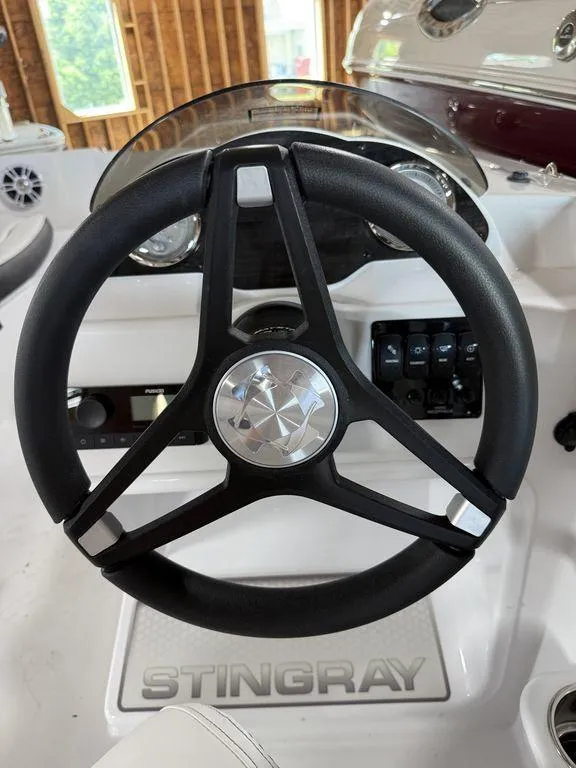 Slide: The Image of Steering wheel of 2025 Stingray 182SC boat, featuring sleek design and modern controls. - 20