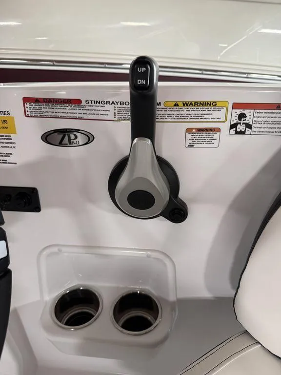 Slide: The Image of 2025 Stingray 182SC boat control panel with throttle lever and cup holders. - 22