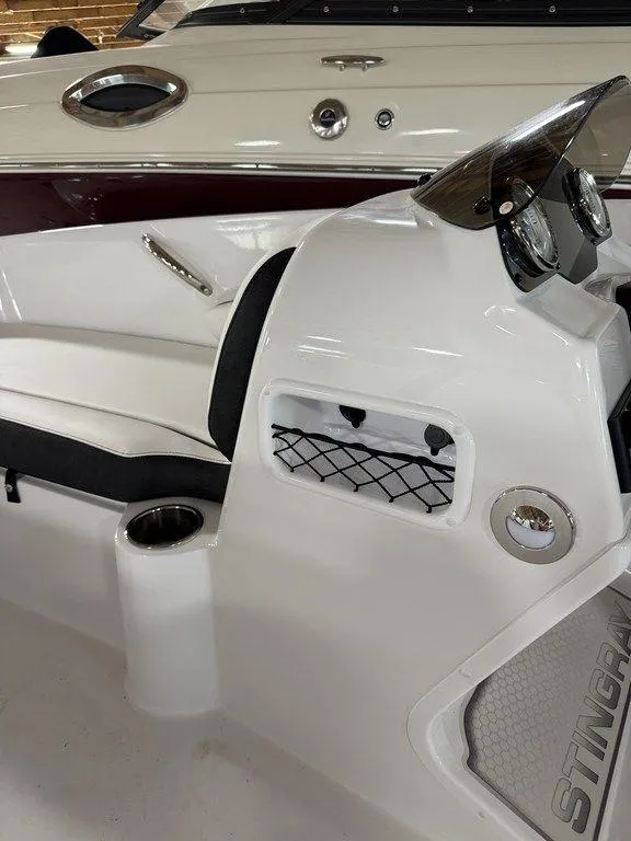 Slide: The Image of 2025 Stingray 182SC boat interior with white seating and dashboard details. - 28