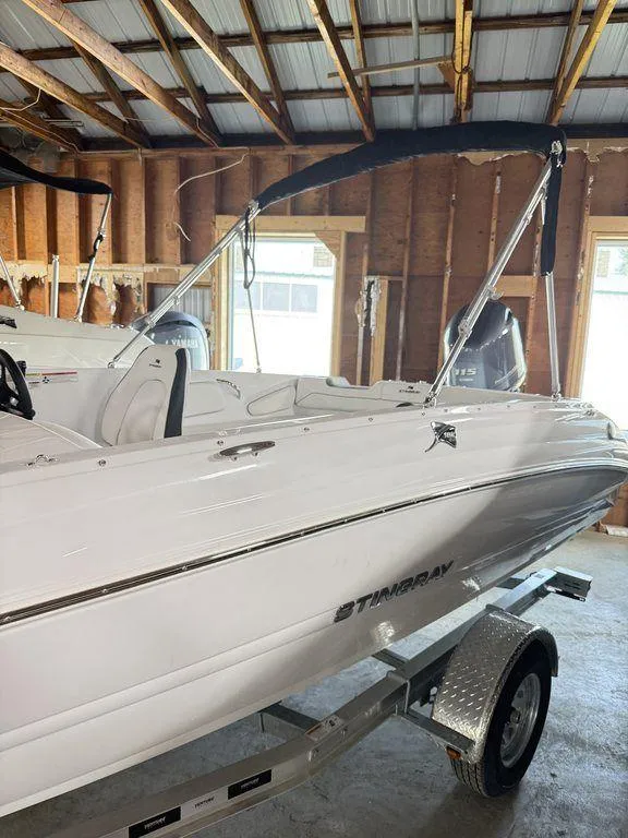 Slide: The Image of 2025 Stingray 182SC boat in a garage, featuring sleek white design and modern build. - 3