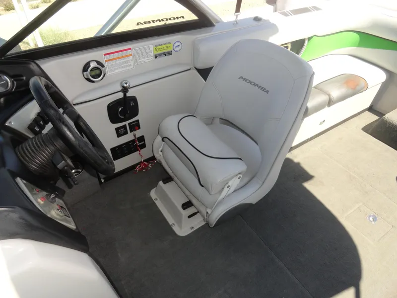 Slide: The Image of 2011 Moomba Outback V boat interior with steering wheel and captain's seat. - 12