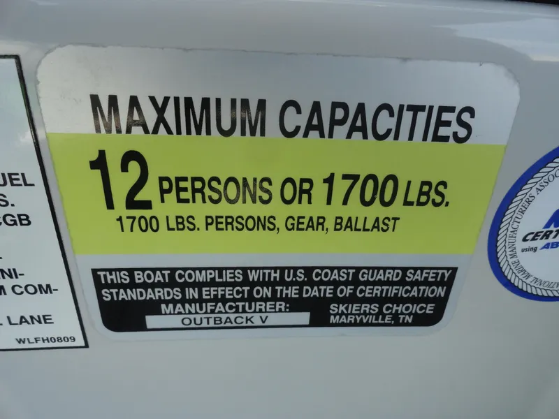 Slide: The Image of 2011 Moomba Outback V capacity label: 12 persons or 1700 lbs, U.S. Coast Guard compliant. - 13