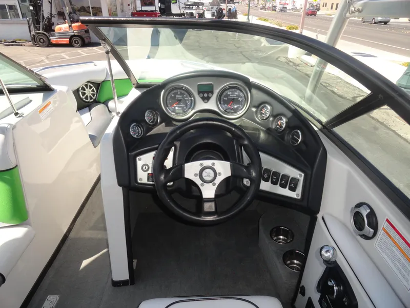 Slide: The Image of 2011 Moomba Outback V boat dashboard with steering wheel and gauges. - 8