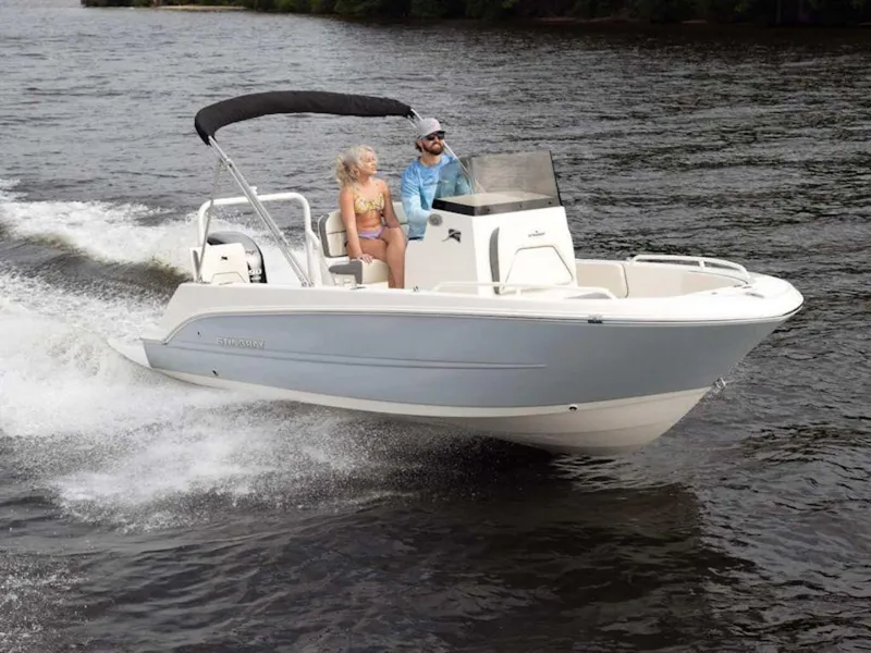 Slide: The Image of 2025 Stingray 173CC boat cruising on a lake with two passengers. - 1