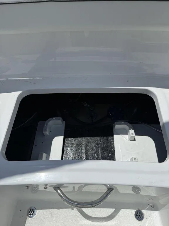 Slide: The Image of Open storage compartment of a 2025 Stingray 172SC boat, featuring a sleek white design. - 17