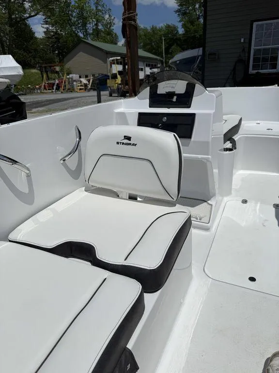 Slide: The Image of 2025 Stingray 172SC boat interior with white seating and dashboard. - 20