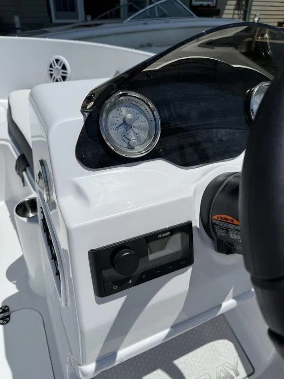 Slide: The Image of 2025 Stingray 172SC boat dashboard with gauges and controls in bright sunlight. - 29