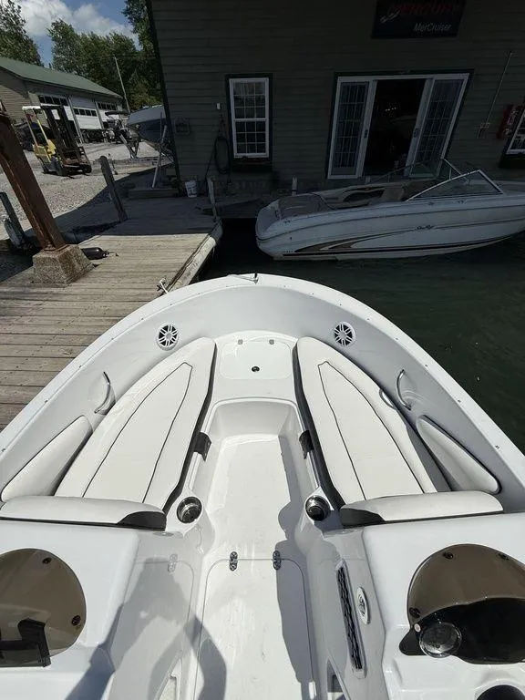 Slide: The Image of 2025 Stingray 172SC boat interior with white seating, docked at a marina. - 30