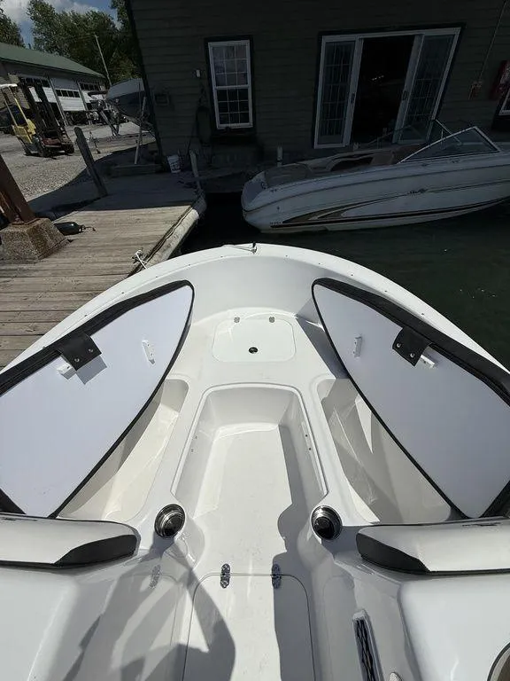 Slide: The Image of 2025 Stingray 172SC boat interior with open storage compartments at dock. - 32