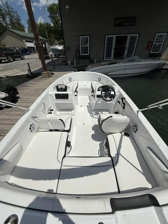 Slide: The Image of 2025 Stingray 172SC boat interior at dock, featuring white seating and steering console. - 4