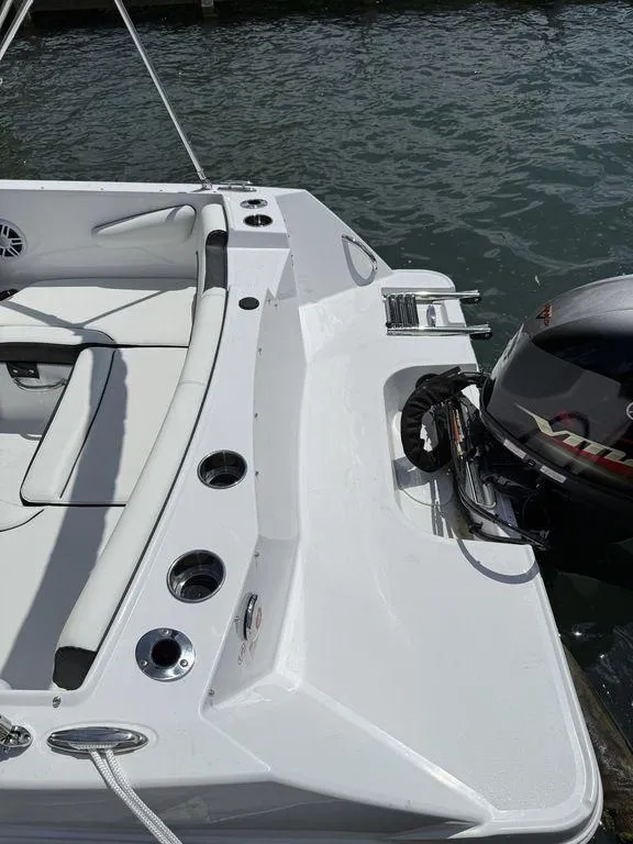 Slide: The Image of 2025 Stingray 172SC boat with outboard motor, docked on calm water. - 7
