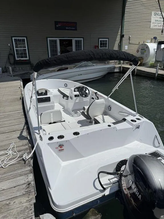 Slide: The Image of 2025 Stingray 172SC boat docked, featuring a Yamaha outboard motor and sleek white design. - 8