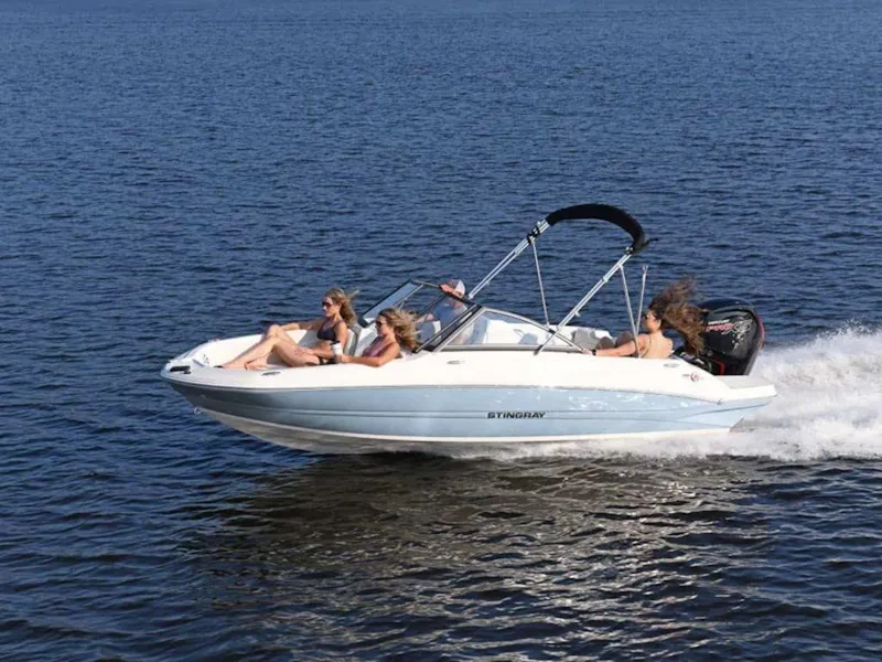 Slide: The Image of 2025 Stingray 191DC boat cruising on open water with passengers enjoying the ride. - 1
