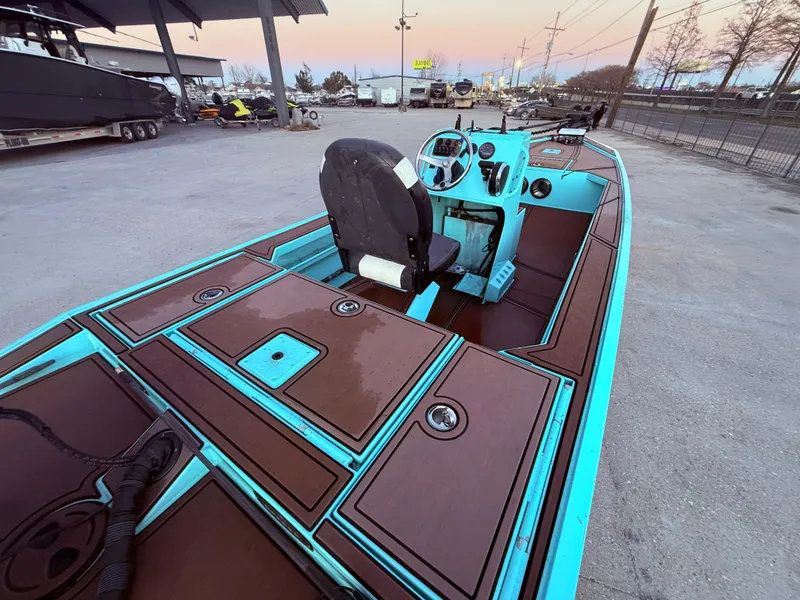 Slide: The Image of Custom Uncle J 19 Bay Center Console Aluminum boat, 2022 model, with teal and brown deck design. - 12