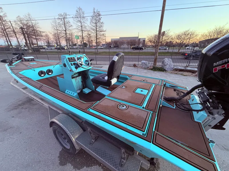 Slide: The Image of Custom Uncle J 19 Bay Center Console Aluminum boat, 2022 model, on trailer at sunset. - 14