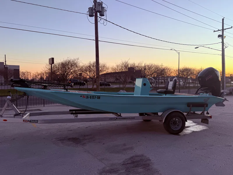 Slide: The Image of 2022 Custom Uncle J 19 Bay Center Console Aluminum boat on trailer at sunset. - 6