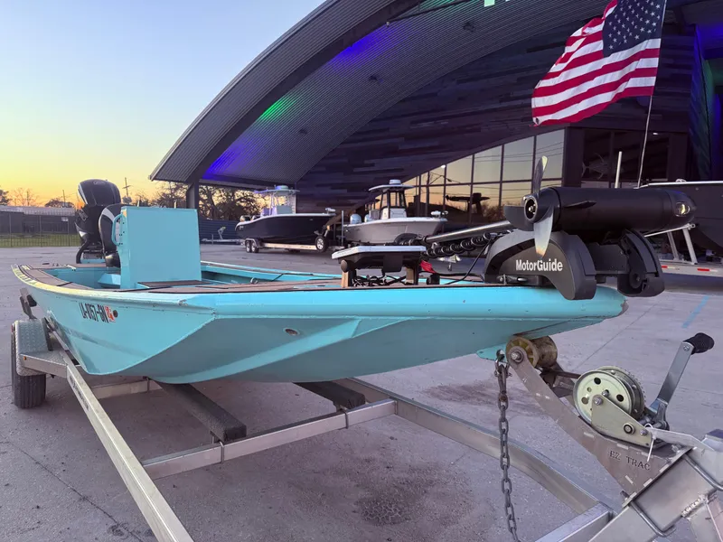 Slide: The Image of 2022 Custom Uncle J 19 Bay Center Console Aluminum boat on trailer, with American flag. - 7