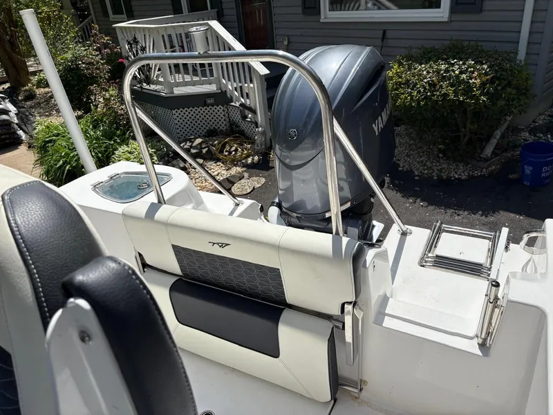 Slide: The Image of 2023 Tidewater 210 CC Adventure boat with Yamaha engine, rear seating, and sleek design. - 6