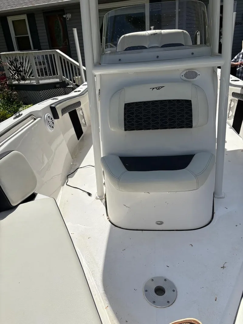 Slide: The Image of 2023 Tidewater 210 CC Adventure boat interior with seating and console. - 7