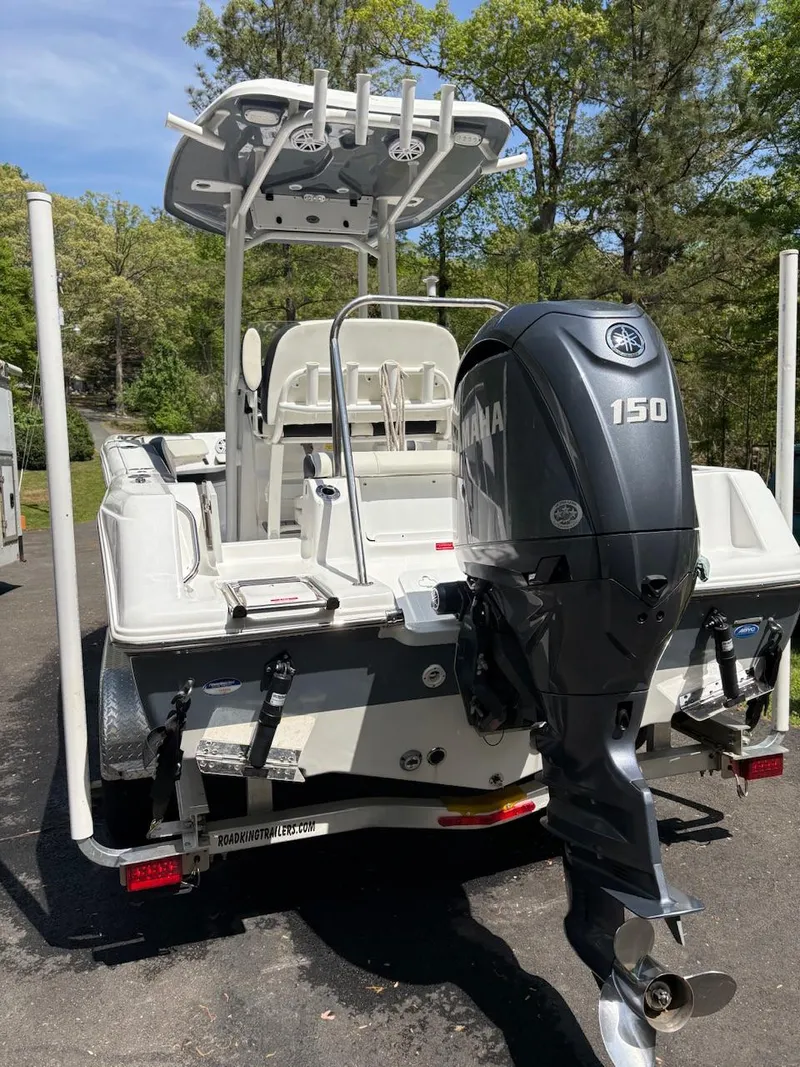 Slide: The Image of 2023 Tidewater 210 CC Adventure boat with Yamaha 150 engine, parked outdoors. - 9