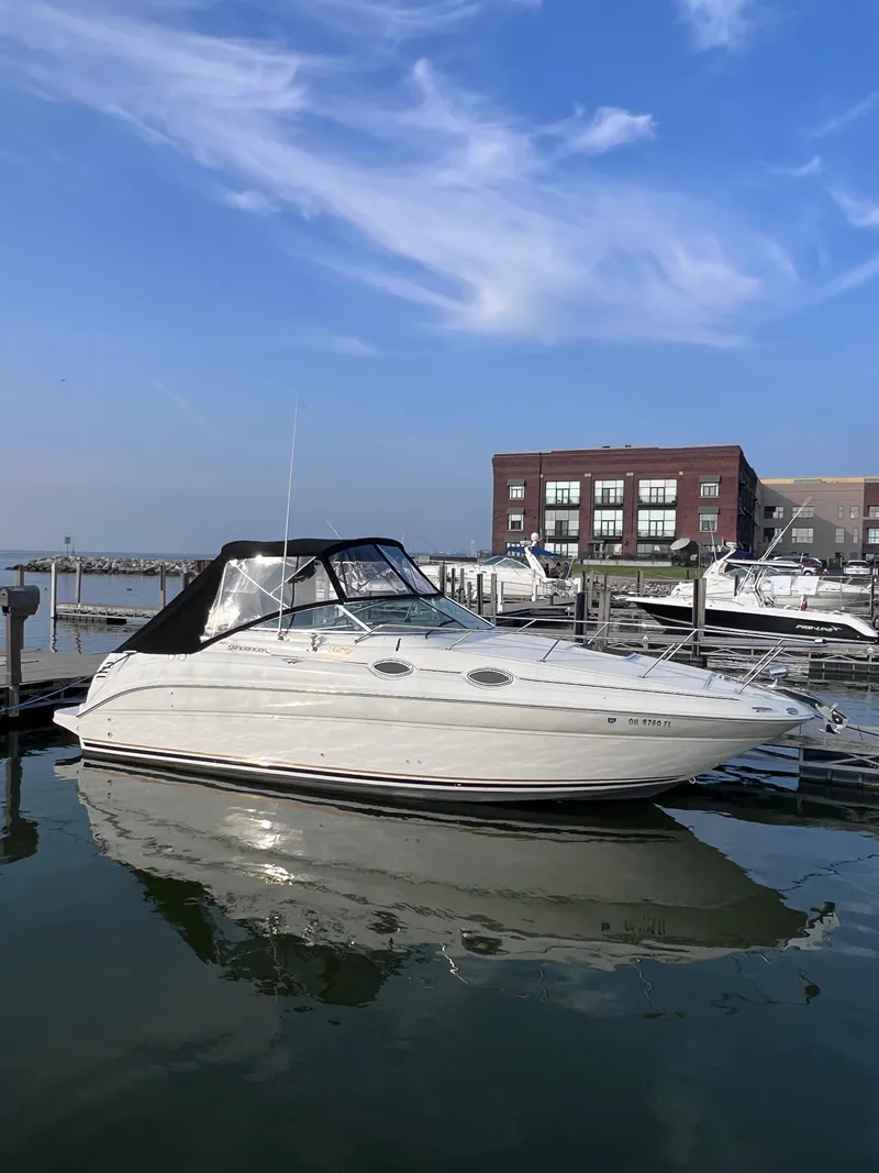 Slide: The Image of 2001 Sea Ray 260 Sundancer boat docked at marina under clear blue sky. - 3