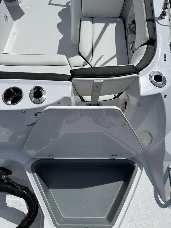Slide: The Image of 2025 Stingray 231DC boat interior with seating and storage compartment. - 10