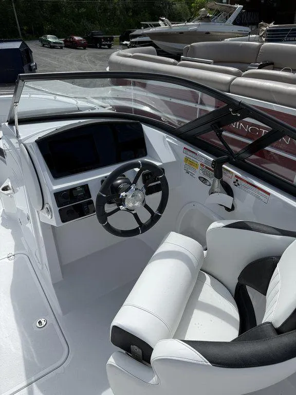 Slide: The Image of 2025 Stingray 231DC boat cockpit with steering wheel and seating. - 17