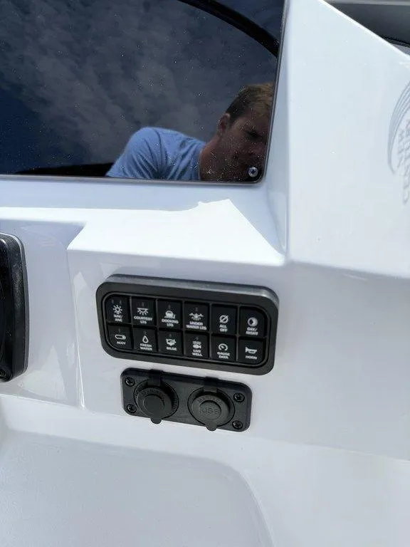 Slide: The Image of Control panel of 2025 Stingray 231DC boat with various switches and ports. - 21