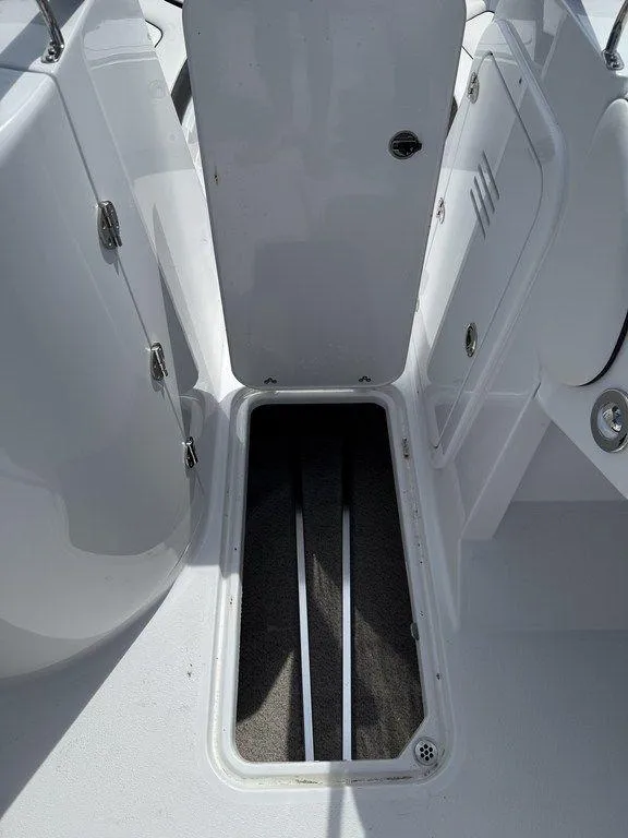 Slide: The Image of 2025 Stingray 231DC boat interior with open storage compartment. - 26