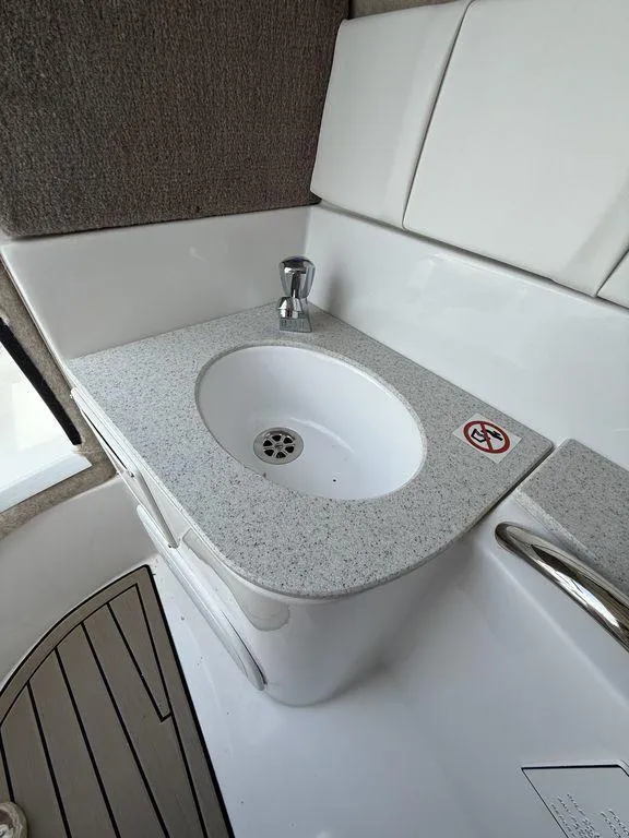 Slide: The Image of 2025 Stingray 231DC boat interior sink with modern design and sleek countertop. - 29