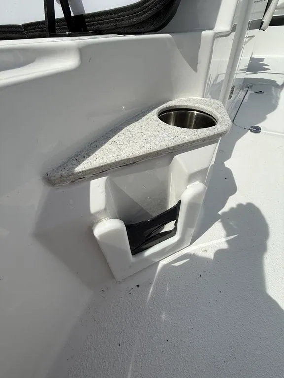 Slide: The Image of 2025 Stingray 231DC boat interior with cup holder and storage compartment. - 30