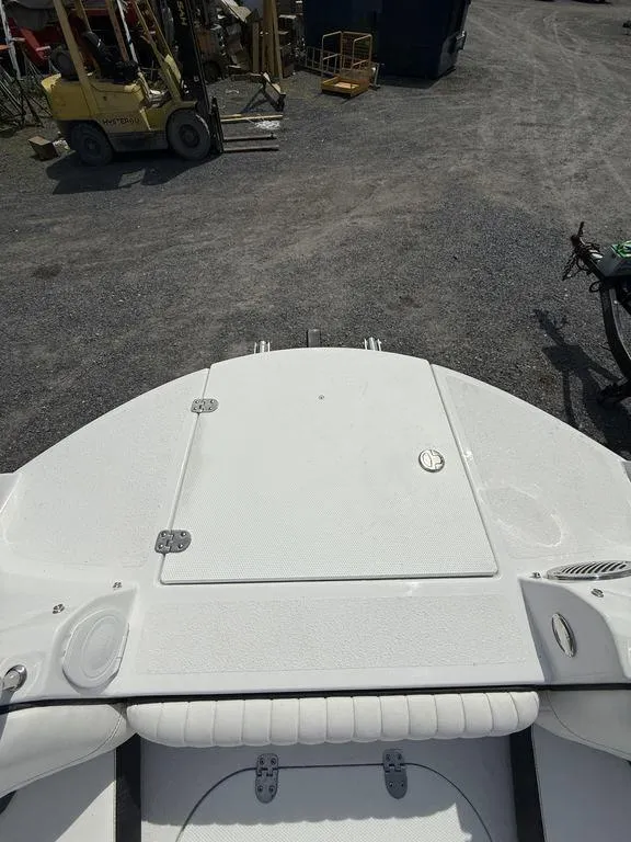 Slide: The Image of 2025 Stingray 231DC boat deck, white surface, outdoor setting with equipment nearby. - 32