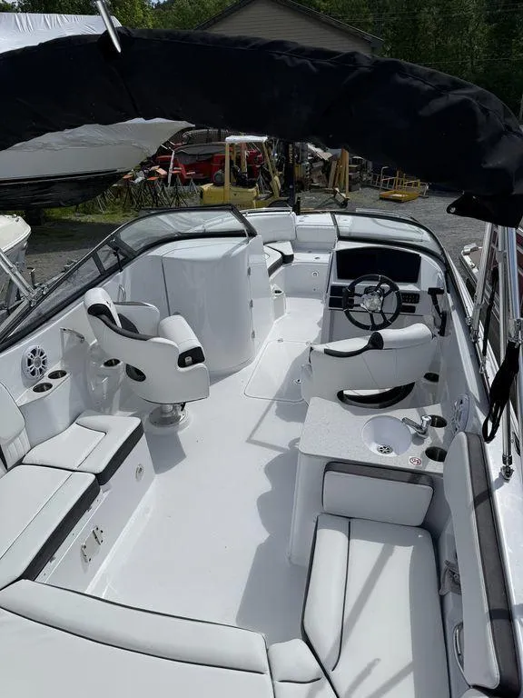 Slide: The Image of 2025 Stingray 231DC boat interior with white seating and modern dashboard. - 8