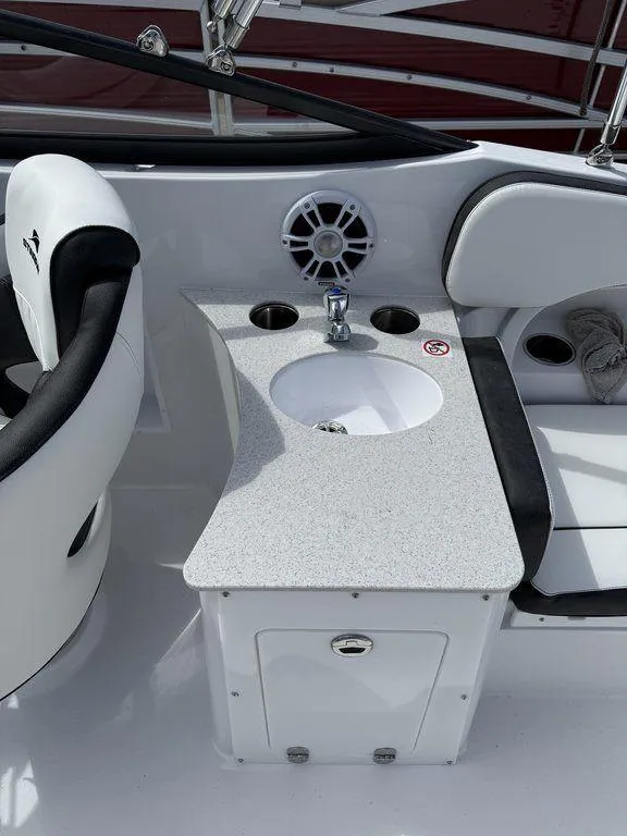 Slide: The Image of 2025 Stingray 231DC boat interior with sink and seating area. - 9