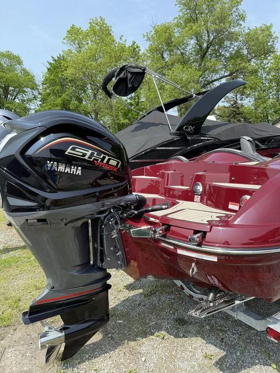 Slide: The Image of 2025 Stingray 23 OSX boat with Yamaha SHO engine, parked outdoors. - 11