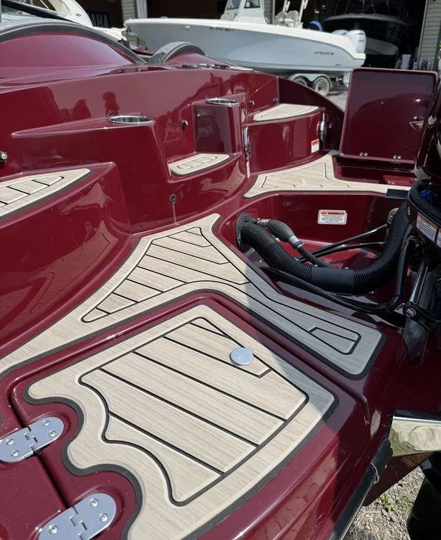 Slide: The Image of 2025 Stingray 23 OSX boat with sleek maroon finish and detailed deck design. - 15
