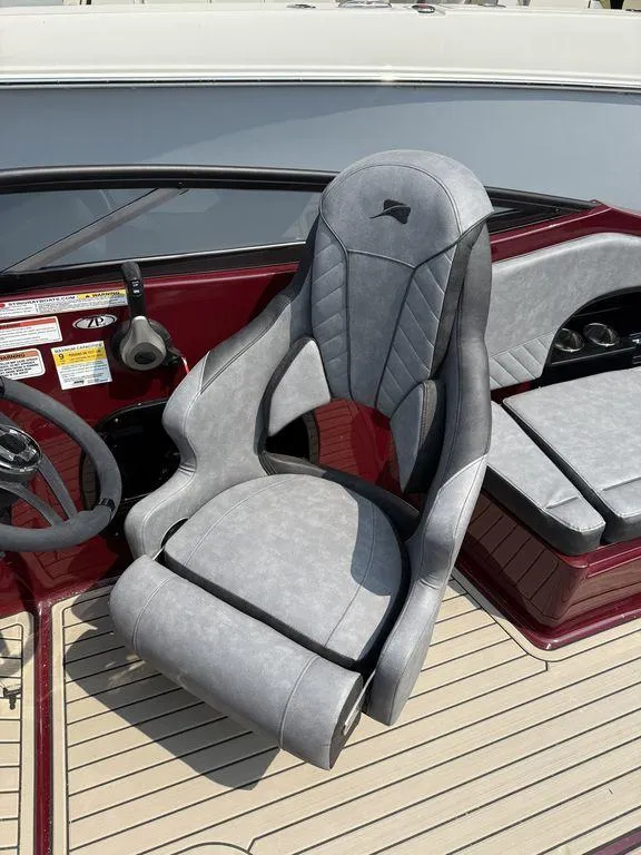 Slide: The Image of 2025 Stingray 23 OSX boat interior with modern gray captain's chair and dashboard. - 20