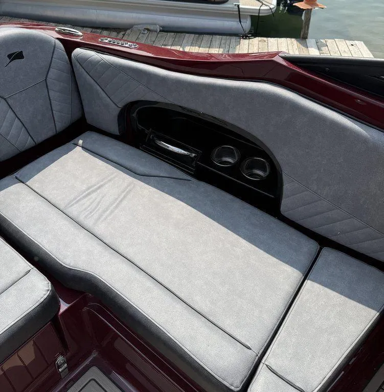 Slide: The Image of 2025 Stingray 23 OSX boat interior with gray seating and maroon accents. - 22