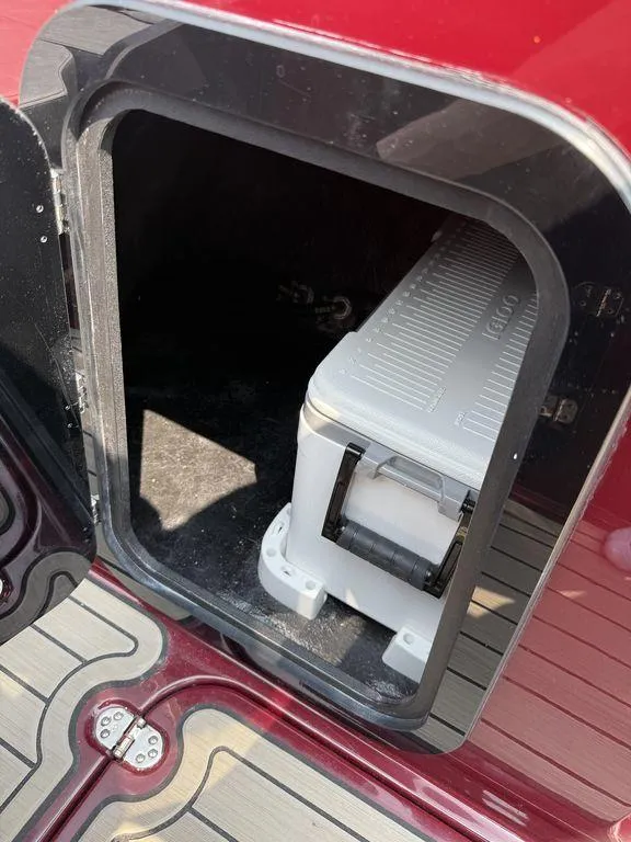 Slide: The Image of Storage compartment on 2025 Stingray 23 OSX boat with cooler inside. - 25