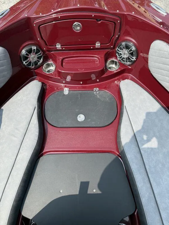Slide: The Image of Interior of 2025 Stingray 23 OSX boat with red and gray seating and audio system. - 30