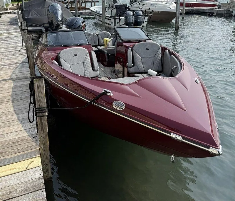 Slide: The Image of 2025 Stingray 23 OSX boat docked, featuring sleek design and modern seating. - 6