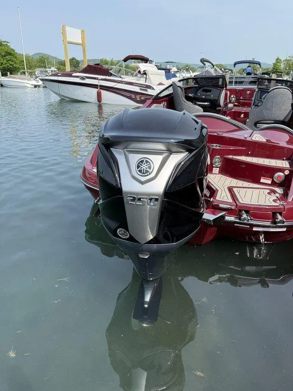 Slide: The Image of 2025 Stingray 23 OSX boat with Yamaha outboard motor docked in a marina. - 9
