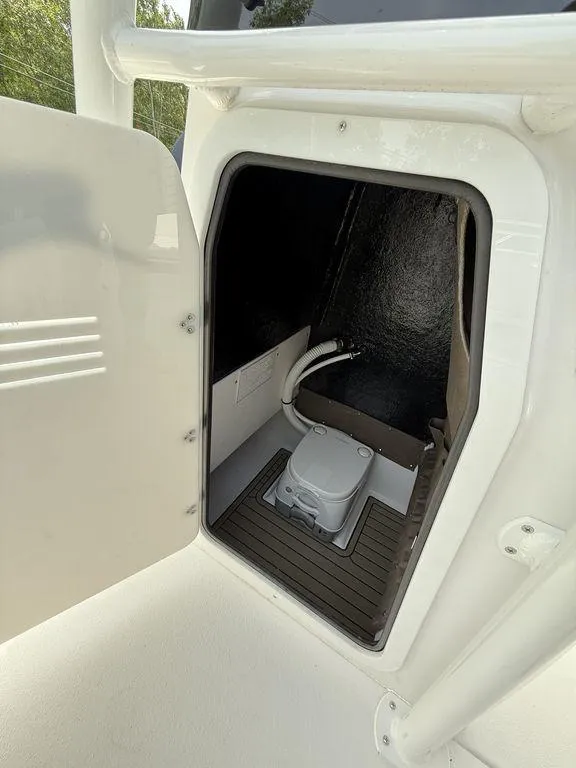 Slide: The Image of 2025 Stingray 216CC boat interior with compact marine toilet. - 16