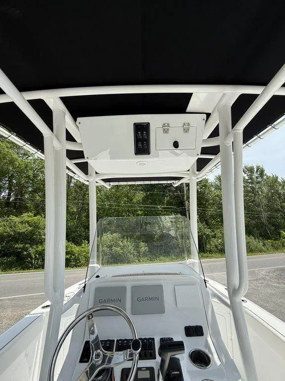 Slide: The Image of 2025 Stingray 216CC boat console with Garmin electronics and black canopy. - 17