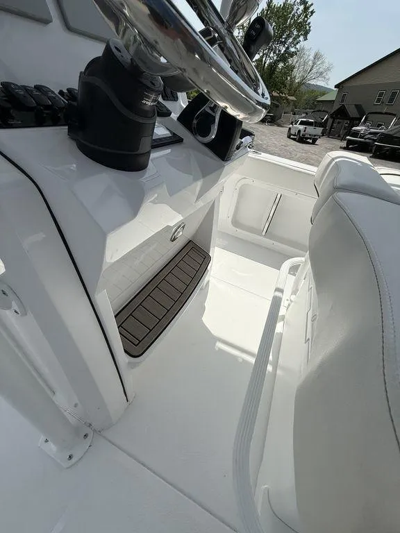 Slide: The Image of 2025 Stingray 216CC boat interior with steering wheel and seating area. - 18
