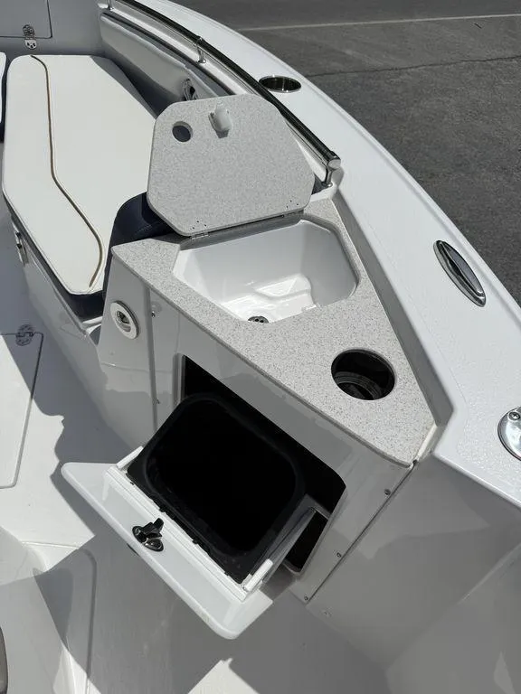 Slide: The Image of 2025 Stingray 216CC boat interior with storage compartments and seating area. - 21